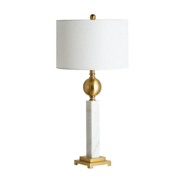 Witte tafellamp naast het bed